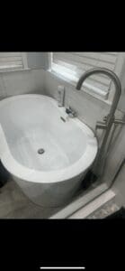 A Bathtub With A Stainless Steel Tap